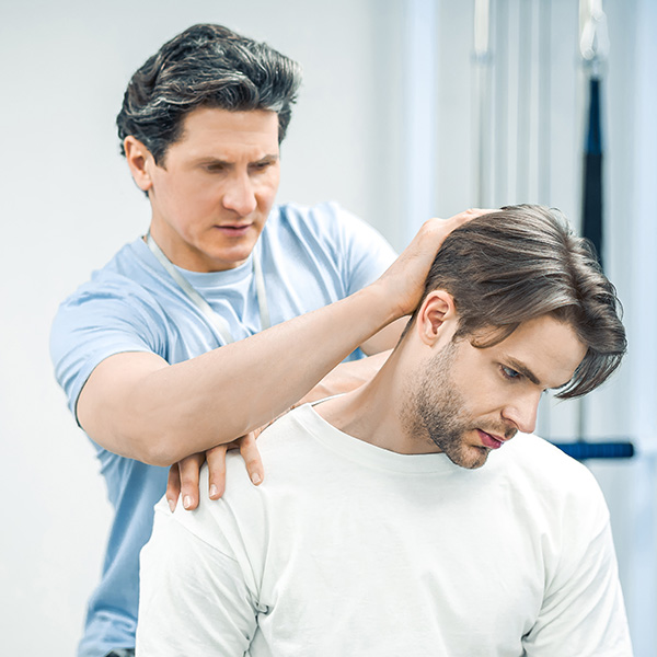Physical therapist working with patients neck