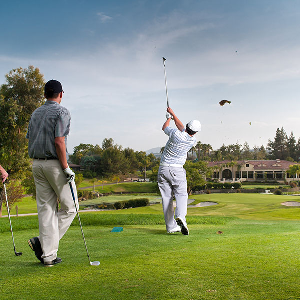 Group of people golfing outdoors