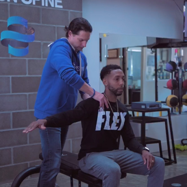 Therapist fixing patient's shoulder