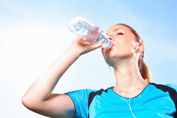 A fit girl drinking water
